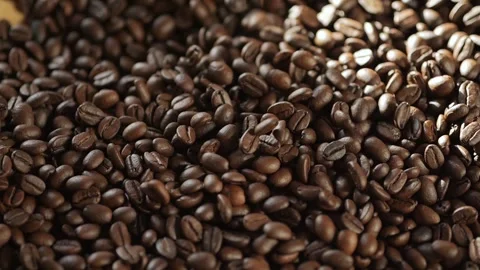 Pile of coffee beans with a lot of them being black Stock Footage 309873771