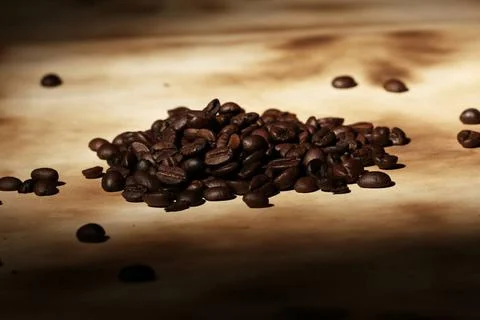 Pile of coffee beans Pile of coffee beans on old paper ,model released, Sy... Stock-Fotos