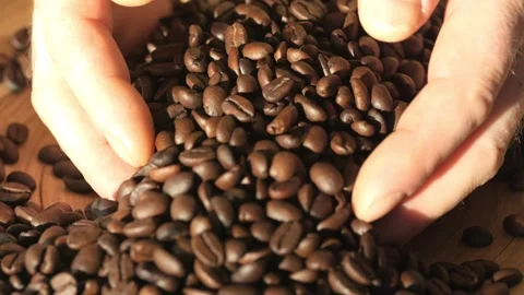 Pile of coffee beans is spread out on a table Stock Footage 302261603