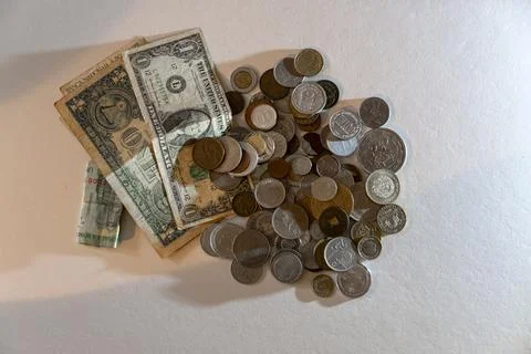 A pile of coins and a dollar bill Stock Photos