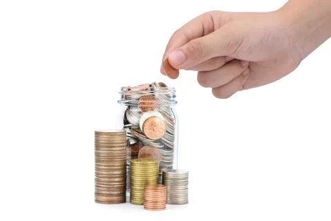 A pile of coins and a hand that is adding coins Concept of business growth, i Stock Photos