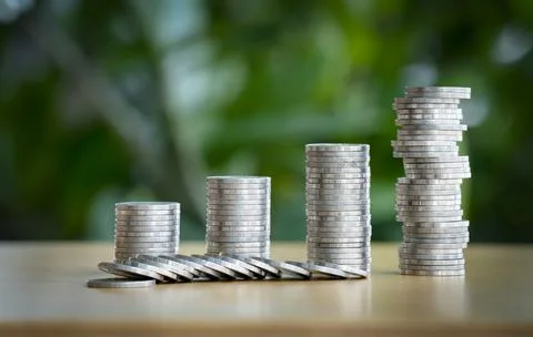 A pile of coins break down. Mini wooden house and row of coin falls. Mortgage 스톡 사진