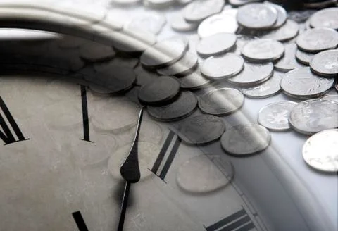 Pile of coins with clock face Stock Photos