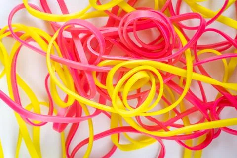 Pile of colorful small rubber bands isolated on a white back ground Stock Photos