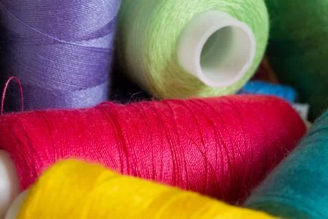 Pile of coloured bobbins of thread 库存照片