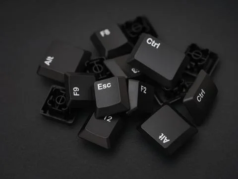 A pile of computer keys on a black background Stock Photos