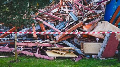 Pile of construction debris with caution tape in residential area outdoors 스톡 사진