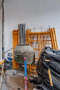 A pile of construction materials including a cement mixer Stock Photos