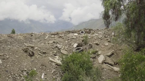 A pile of construction waste. Concrete rubble, old tires and plastic debris. Stock Footage 272467003