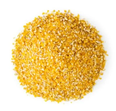 Pile of corn grits on a white. The form of the top. Stock Photos