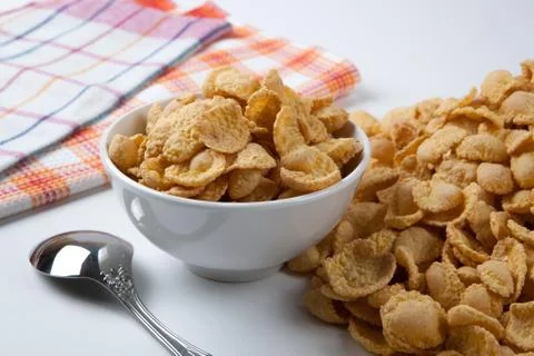 Pile of cornflakes and a spoon Stock Photos