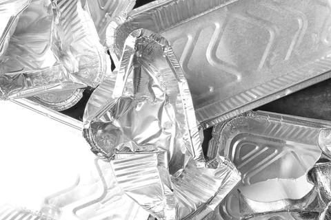 Pile of crumpled foil containers as background, top view. Recycling problem Stock Photos