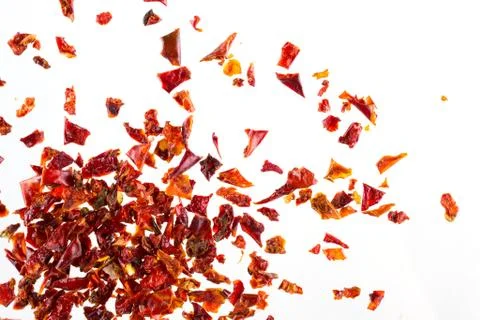 Pile crushed  dried red pepper flakes, on white background, top view Stock Photos