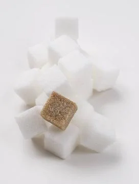 Pile of cubes stack of white sugar cube with one brown sugar cube Copyrigh... Stockfoto's