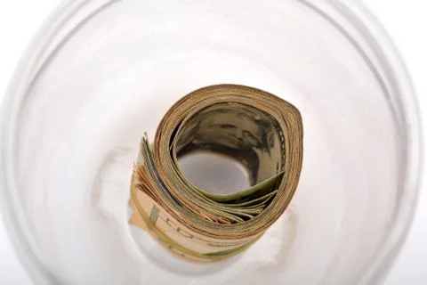 Pile of currency notes in jar Stock Photos