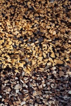 Pile of cut, thinly split and neatly stacked spruce firewood viewed from fron Stock Photos