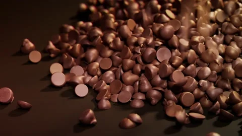 The pile of dark chocolate chips the brown background. Sweet temptation. Candies Stock Footage 201193772