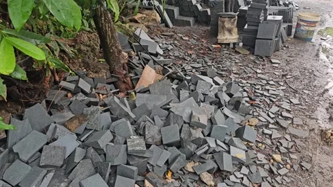 Pile of Dark Grey Stone Offcuts and Broken Tiles Near Tree Stock Footage 332058622