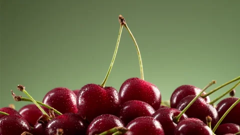 A pile of delicious cherries on a green gradient background. Stock Footage 314179293