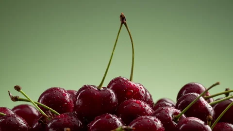 A pile of delicious cherries on a green gradient background. Stock Footage 314179312