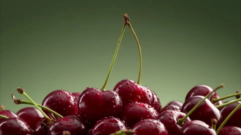 A pile of delicious cherries on a green gradient background. 動画素材 314179340
