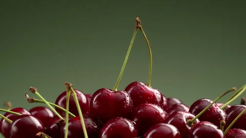 A pile of delicious cherries on a green gradient background. Stock Footage 314179400