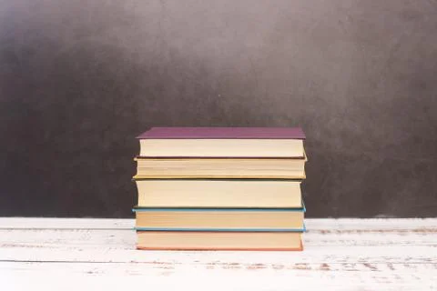 Pile of different books on the table Stock Photos