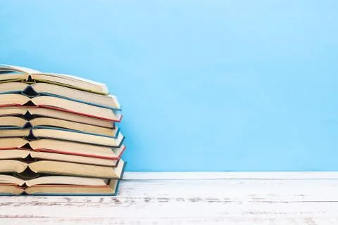 Pile of different books on the table Stock Photos