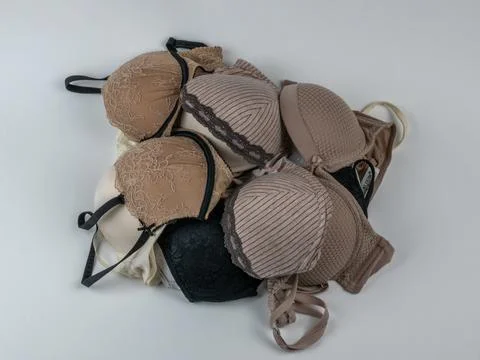 A pile of different classic women's bras on a light background close-up Stock Photos