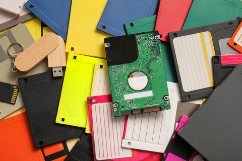 Pile of different memory storage devices on beige background Stock Photos