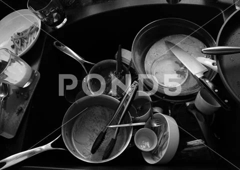 PILE OF DIRTY DISHES IN BLACK AND WHITE Stock Photos