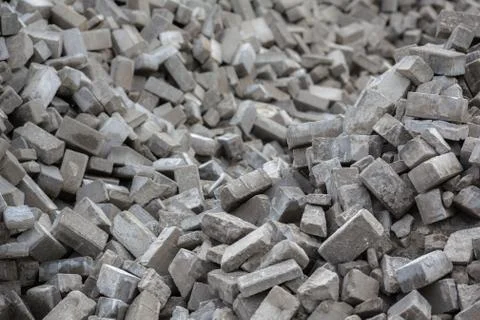 Pile of disassembled gray pavement bricks with selective focus Stock Photos