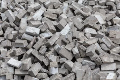 Pile of disassembled gray pavement bricks with selective focus Фото