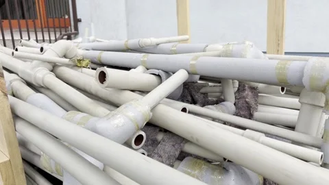 A pile of disassembled plastic water pipes with foam thermal insulation lie.. Stock Footage 341492385