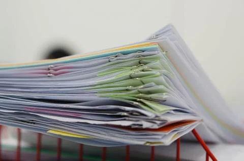 Pile of documents and blur notebook in basket Stock Photos