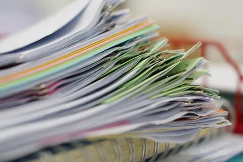 Pile of documents and notebook in red basket Stock Photos
