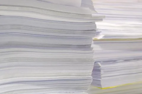 Pile of documents on desk stack up high waiting to be managed Stock Photos