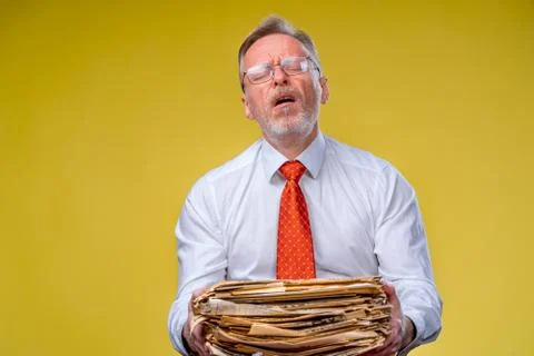 Pile of documents in hands. Senior man holding piles of documents paper work. Stock Photos