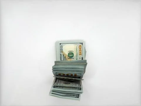 A pile of dollars lies on a flat surface in a folded form in the center of the Foto stock