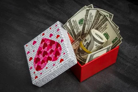 Pile of dollars in a red gift box Stock Photos