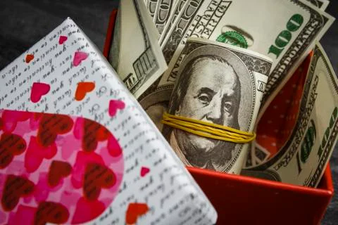 Pile of dollars in a red gift box Stock Photos