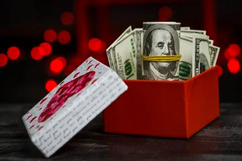 Pile of dollars in a red gift box Stock Photos