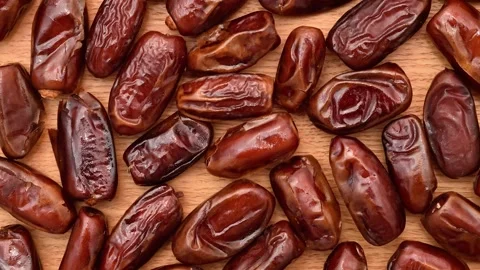 Pile of dried dates on the wooden table Stock Footage 325652942