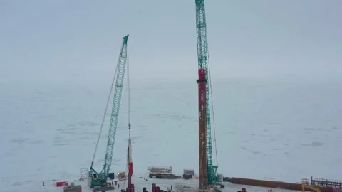 The pile driver drives the pile into the ground. Stock Footage 153469161