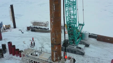 The pile driver drives the pile into the ground. Stock Footage 154690540