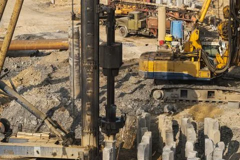 The pile driver hammers the pile. Stock Photos