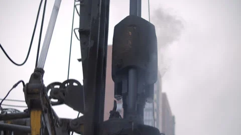 Pile driving hammer operating at construction site in winter Stock Footage 327041458