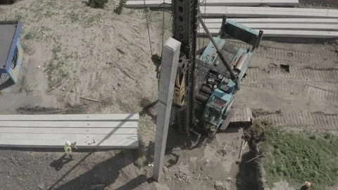 Pile driving machine driving piles into ground site. Stock Footage 231998754