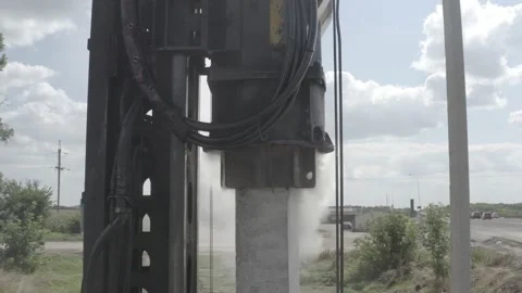 Pile driving machine driving piles into ground site. Stock Footage 231998758