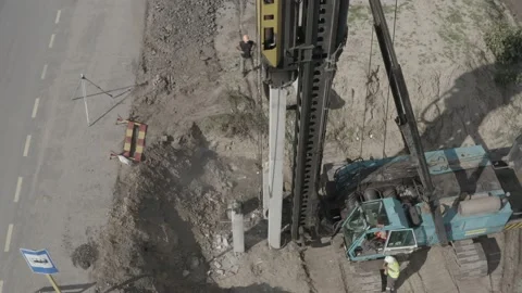 Pile driving machine driving piles into ground site. Stock Footage 231998763